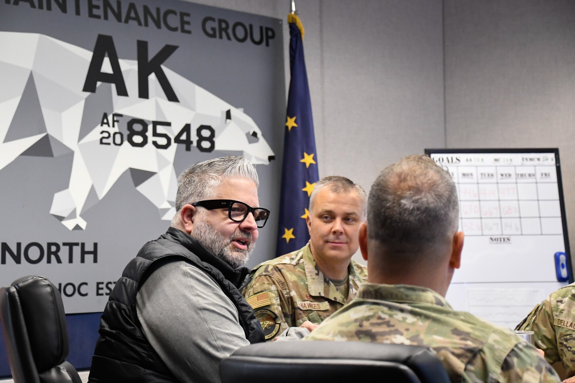 Jim Matherly, Honorary Commander of the 168th Aircraft Maintenance visits with the 168th Wing Airmen during a meeting.