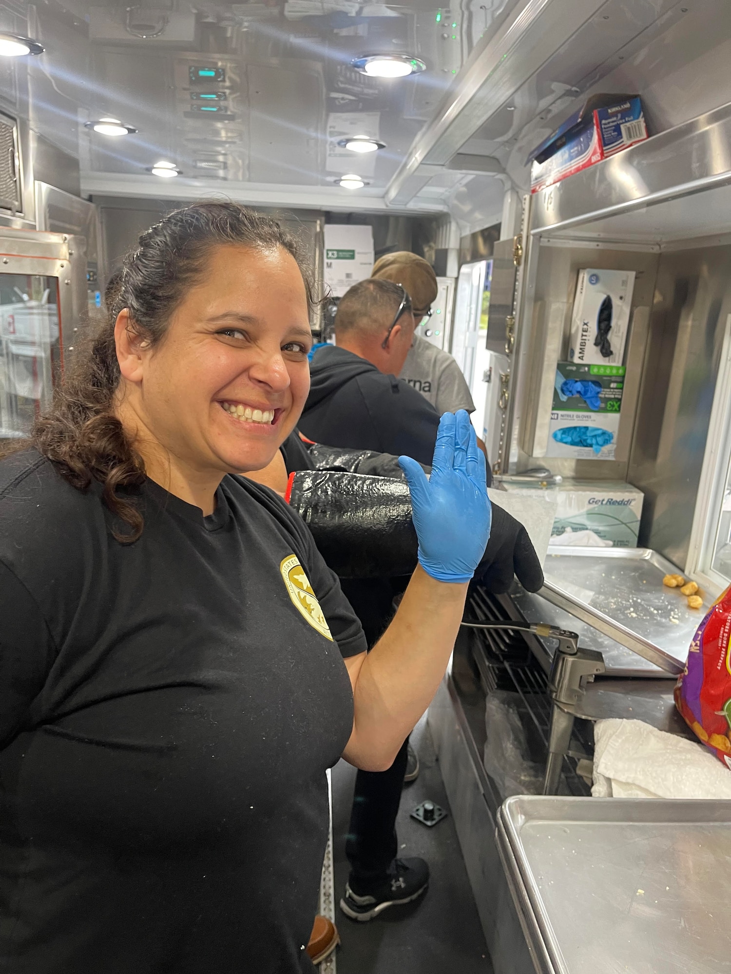 Senior Airman April Dishneau of the 168th Wing Force Support Squadron, 168th Services, prepares meals during the Fairbanks Veterans Stand Down event at the Pioneer Park Civic Center