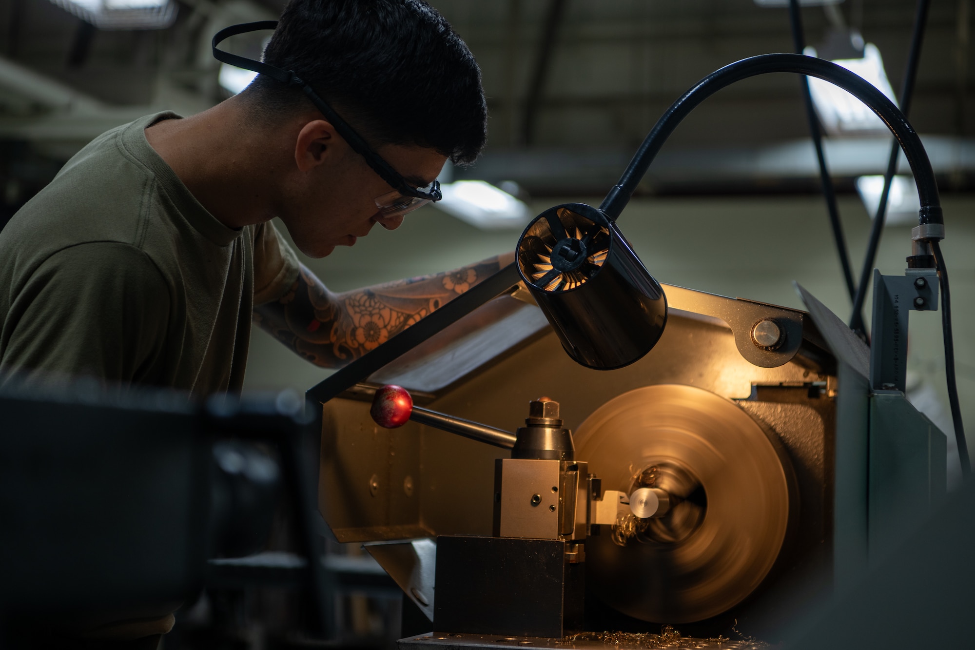Airman monitoring a lathe machine