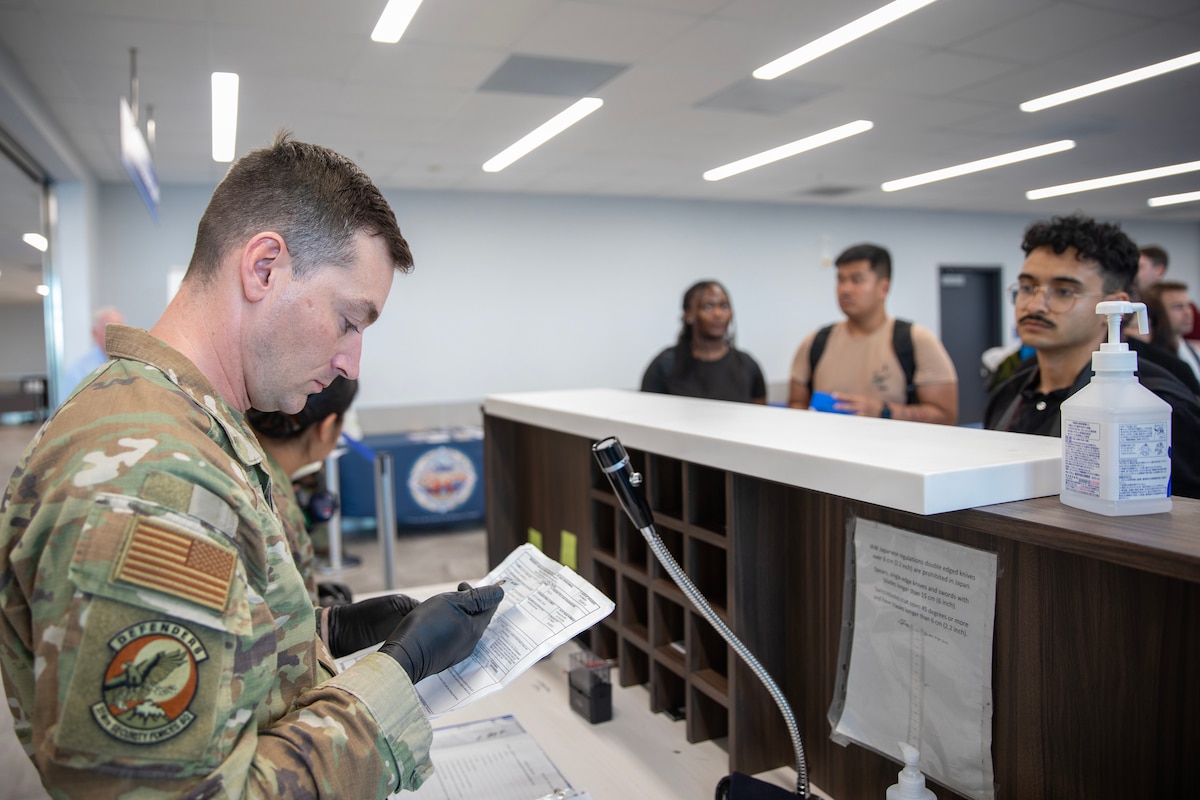 An Airman reviewing documents over the counter