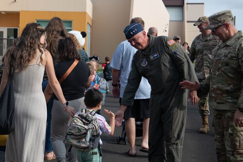 U.S. Air Force Lt. Gen. Ricky Rupp, U.S. Forces Japan and 5th Air Force commander, high-fives a student.