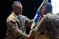 Col. Robert L. Le'iato, commandant of the Finance and Comptroller School and chief of the Finance Corps, receives the school colors from Col. Jason T. Edwards, Soldier Support Institute commander during a ceremon held in the institute's auditorium, July 30, 2024. (U.S. Army photo by Robert Timmons)