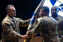 Col. Robert L. Le'iato, commandant of the Finance and Comptroller School and chief of the Finance Corps, receives the school colors from Col. Jason T. Edwards, Soldier Support Institute commander during a ceremon held in the institute's auditorium, July 30, 2024. (U.S. Army photo by Robert Timmons)
