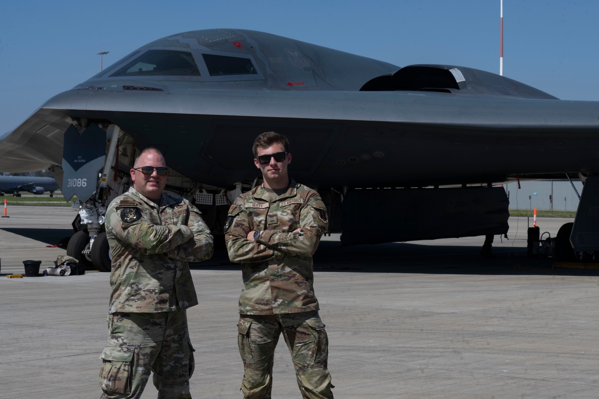 U.S. Air Force Chief Master Sgt. Adam Hufty, 110th Expeditionary Bomb Squadron senior enlisted leader, and Airman 1st Class Ashton Hufty, 110th EBS all source intelligence analyst, pose in front of a B-2 Spirit stealth bomber during their Bomber Task Force deployment at Royal Australian Air Force Base Amberley, Australia, Sept. 4, 2024. This father and son share more than 20 years of U.S. Air Force experience together as Adam, brings 19 years of knowledge, while his son, Ashton brings just over one year of service under his belt. (U.S. Air Force photo by Tech. Sgt. Anthony Hetlage)