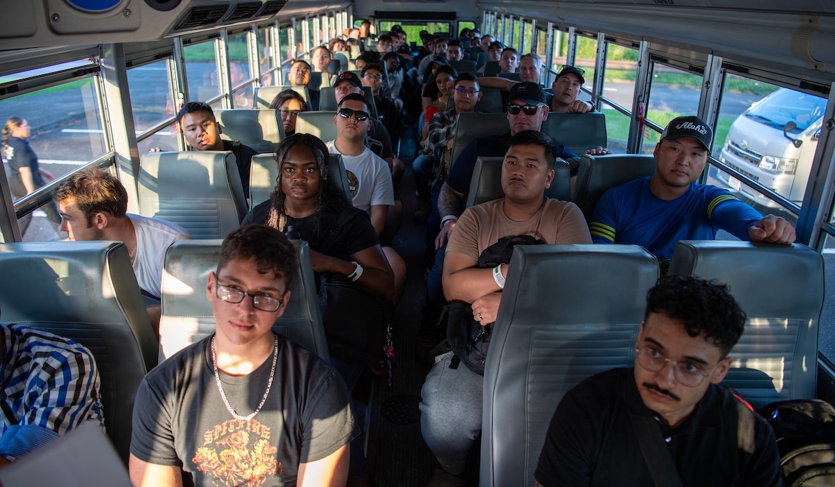 A wide-angle view inside of a bus with people sitting