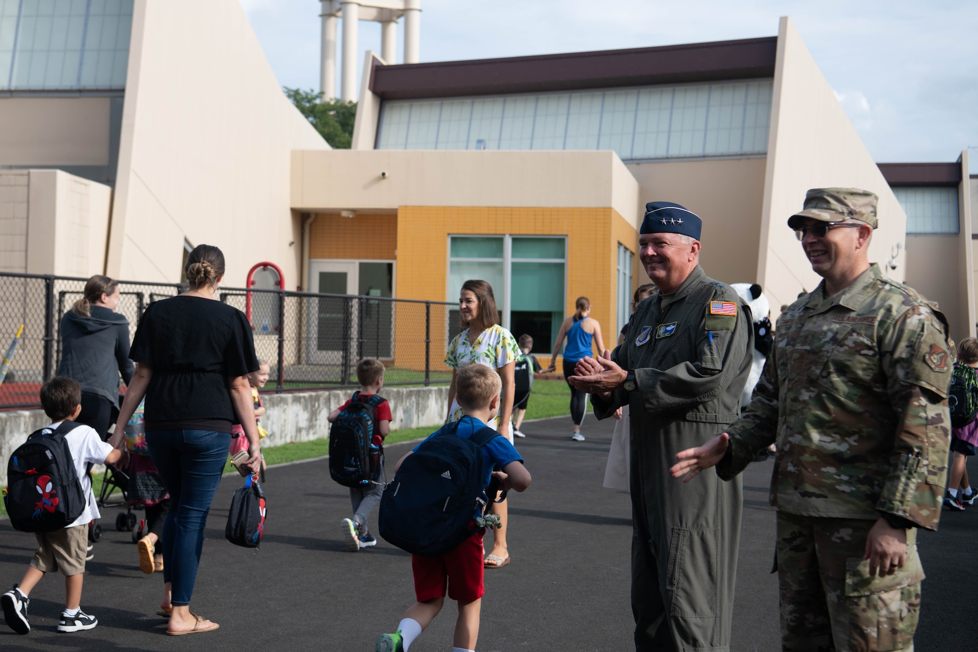 U.S. Air Force Lt. Gen. Ricky Rupp, U.S. Forces Japan and 5th Air Force commander, and Chief Master Sgt. Shaun Campbell, 5AF command chief, welcome parents and students to Mendel Elementary School.