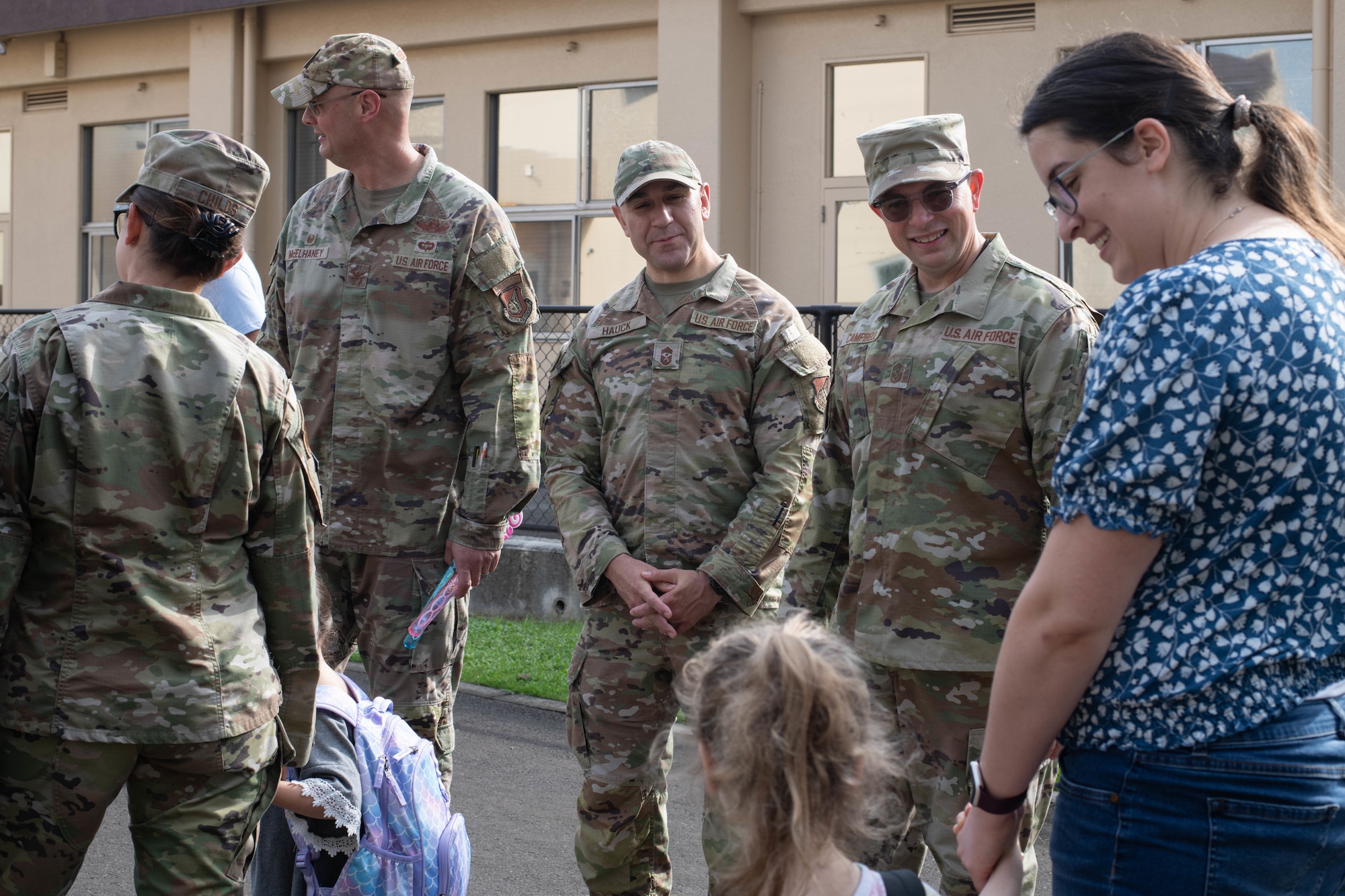 From left, U.S. Air Force Col. Richard McElhaney, 374th Airlift Wing commander; Chief Master Sgt. Kenneth Hauck, 374th AW command chief, and Chief Master Sgt. Shaun Campbell, 5th Air Force command chief, welcome parents and students.