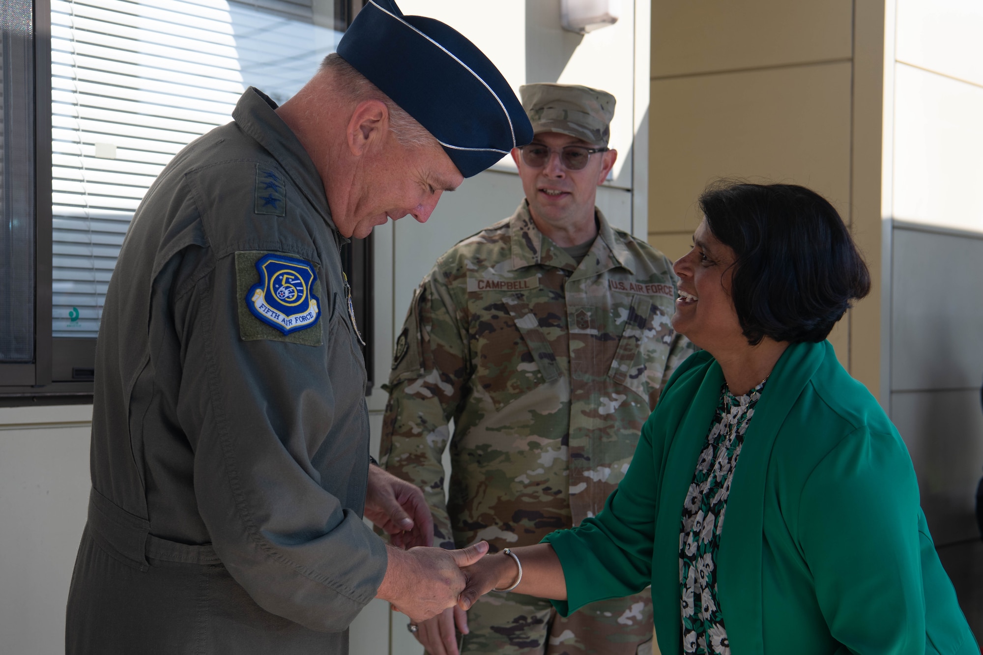 U.S. Air Force Lt. Gen. Ricky Rupp, U.S. Forces Japan and 5th Air Force commander, receives a commemorative coin from Anita Macgrath, Yokota West Elementary School principal.