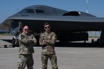 U.S. Air Force Chief Master Sgt. Adam Hufty, 110th Expeditionary Bomb Squadron senior enlisted leader, and Airman 1st Class Ashton Hufty, 110th EBS all source intelligence analyst, pose in front of a B-2 Spirit stealth bomber during their Bomber Task Force deployment at Royal Australian Air Force Base Amberley, Australia, Sept. 4, 2024. This father and son share more than 20 years of U.S. Air Force experience together as Adam, brings 19 years of knowledge, while his son, Ashton brings just over one year of service under his belt. (U.S. Air Force photo by Tech. Sgt. Anthony Hetlage)