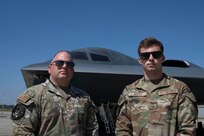 U.S. Air Force Chief Master Sgt. Adam Hufty, 110th Expeditionary Bomb Squadron senior enlisted leader, and Airman 1st Class Ashton Hufty, 110th EBS all source intelligence analyst, pose in front of a B-2 Spirit stealth bomber during their Bomber Task Force deployment at Royal Australian Air Force Base Amberley, Australia, Sept. 4, 2024. Adam is serving in the final years of his career while son, Ashton has just begun his Air Force career with just more than one year served. (U.S. Air Force photo by Tech. Sgt. Anthony Hetlage)