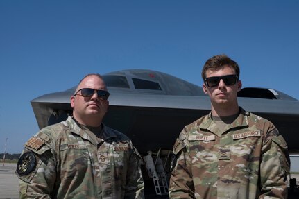 U.S. Air Force Chief Master Sgt. Adam Hufty, 110th Expeditionary Bomb Squadron senior enlisted leader, and Airman 1st Class Ashton Hufty, 110th EBS all source intelligence analyst, pose in front of a B-2 Spirit stealth bomber during their Bomber Task Force deployment at Royal Australian Air Force Base Amberley, Australia, Sept. 4, 2024. Adam is serving in the final years of his career while son, Ashton has just begun his Air Force career with just more than one year served. (U.S. Air Force photo by Tech. Sgt. Anthony Hetlage)