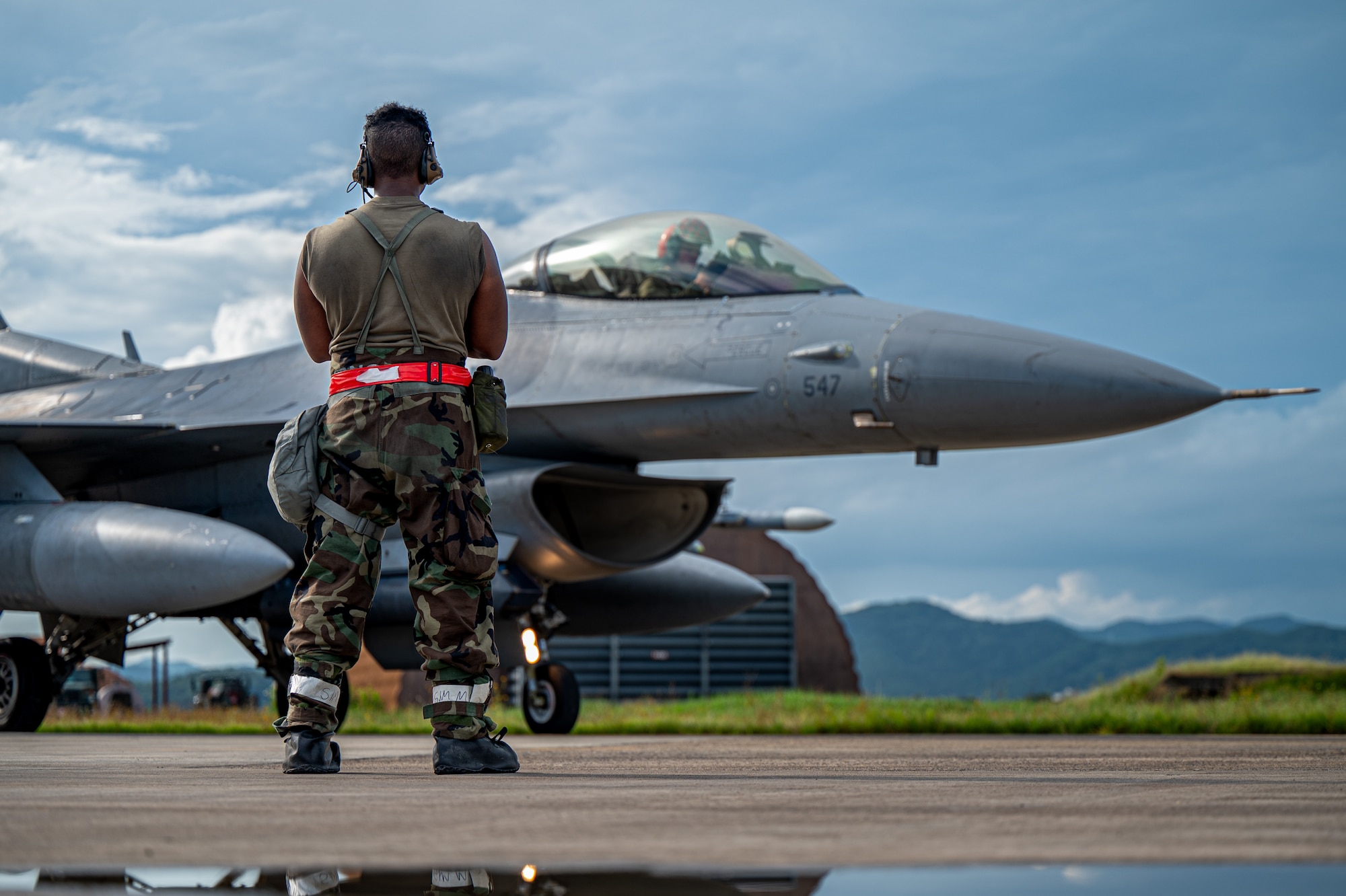 U.S. Air Force Senior Airman Adrian Quiroz, 36th Fighter Generation Squadron crew chief, prepares an F-16 Fighting Falcon aircraft for takeoff during Ulchi Freedom Shield 24 at an unspecified location in the Republic of Korea, Aug. 21, 2024. Executing agile combat employment operations during this comprehensive joint training event ensures the 51st Fighter Wing can rapidly deploy and sustain operations under diverse and unpredictable circumstances. UFS24 is an annual combined exercise conducted in support of the U.S.-ROK Mutual Defense Treaty that highlights the U.S.’s commitment to the alliance. (U.S. Air Force photo by Senior Airman Brittany Russell)