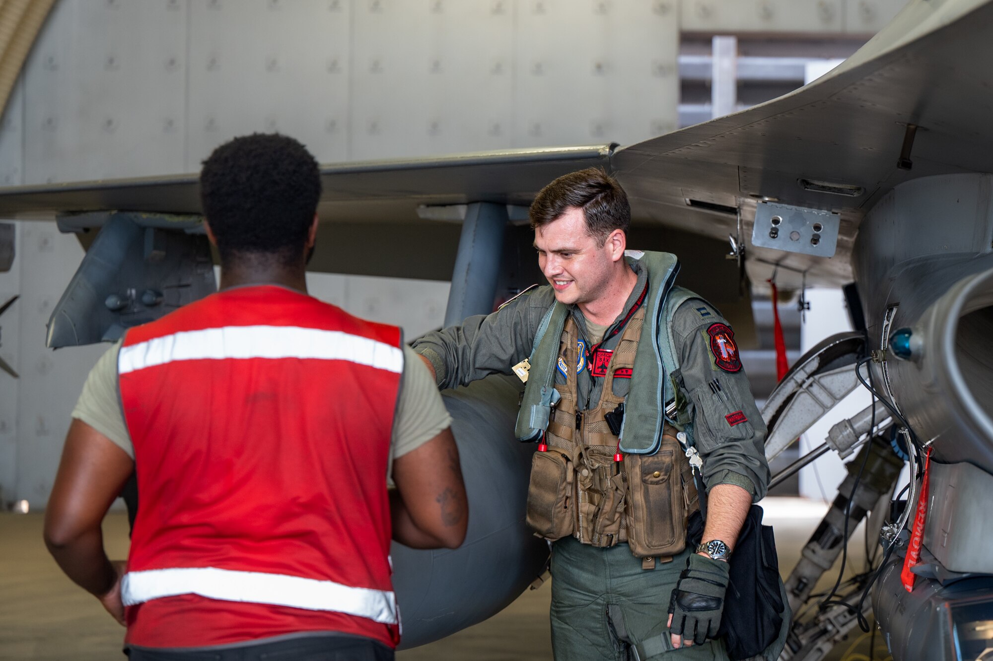 U.S. Air Force Capt. Christopher Newman, right, 36th Fighter Squadron pilot, performs pre-flight inspections during Ulchi Freedom Shield 24 at a cooperating base location in the Republic of Korea, Aug. 22, 2024. The 51st Fighter Wing participated in UFS24 to enhance agile combat employment capabilities during UFS24, ensuring aircraft and personnel are always ready to “Fight Tonight.” UFS24 serves as a regular exercise between the ROK and the U.S., ensuring constant preparedness for military forces.  (U.S. Air Force photo by Senior Airman Brittany Russell)