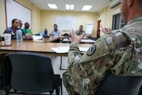 Louisiana Army National Guard Chaplain Col. David Yellott reviews training and evaluations with the Belize Defence Force Wellness Team and Coast Guard leadership during a State Partnership Program wellness exchange at Price Barracks in Ladyville, Belize, Aug. 20, 2024.