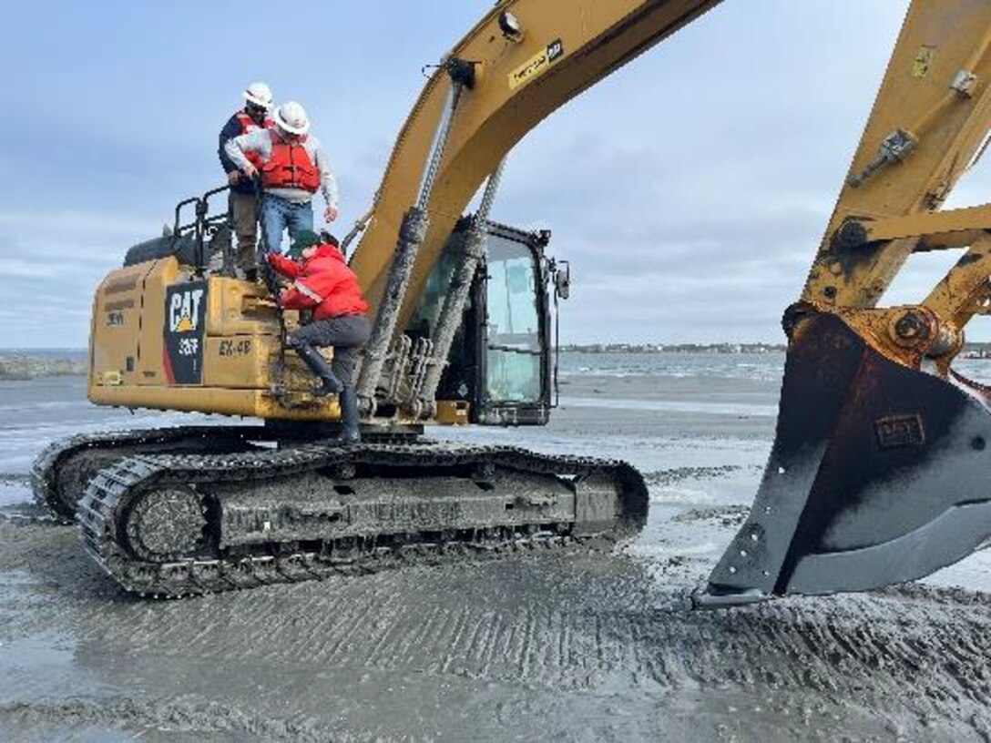 John Policarpo, Dean, Hill and Carmen Johnson set off an excavator being used to restore Sandbag Island. Photo Credit: Andrea Currylow (US Army Corps of Engineers)