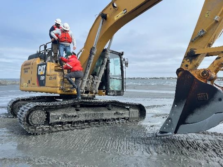 John Policarpo, Dean, Hill and Carmen Johnson set off an excavator being used to restore Sandbag Island. Photo Credit: Andrea Currylow (US Army Corps of Engineers)