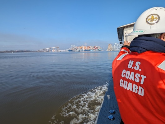 ASOFR LT Michael Gonzalez onboard an asset making rounds to each worksite on the water with the bridge destruction captured in the background.