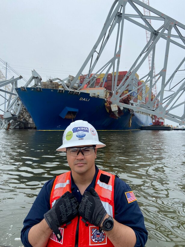 ASOFR LT Michael Gonzalez conducting daily rounds with the MV Dali in the background. The team went from barge to barge building rapport with the multiple contractors and oversaw safety for the entire operation as the Federal On-Scene Coordinator.