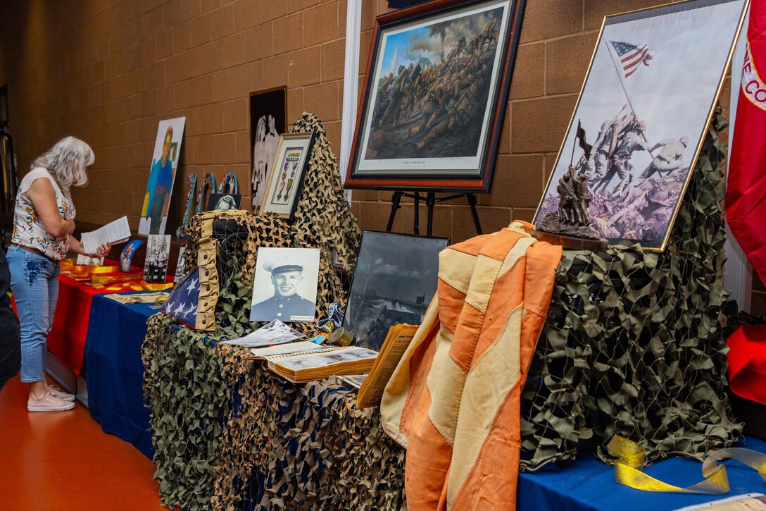 A wall displaying memorabilia was present at U.S. Marine Corps veteran Robert Brutinel 100th birthday celebration at the St. Anthony of Padua Community Center, Casa Grande, Ariz., Aug. 31, 2024. Marines with Recruiting Station Phoenix attended the celebration and presented Brutinel with gifts as a thank you for his honorable service during Iwo Jima. (U.S. Marine Corps photo by Sergeant Symira Bostic)