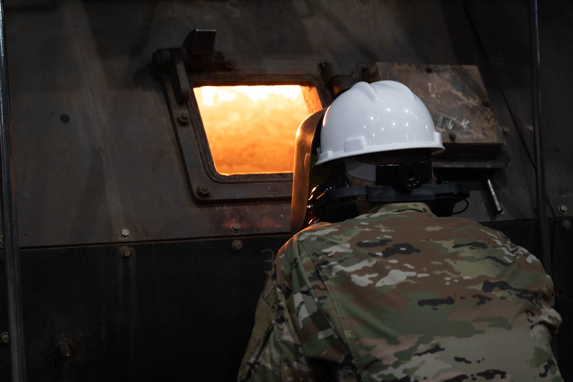 U.S. Air Force Lt. Gen. Case Cunningham, commander, Alaskan North American Aerospace Defense Region, Alaskan Command, and Eleventh Air Force, examines a coal furnace at the Central Heat and Power Plant during an immersion tour at Eielson Air Force Base, Alaska, Aug. 28, 2024.