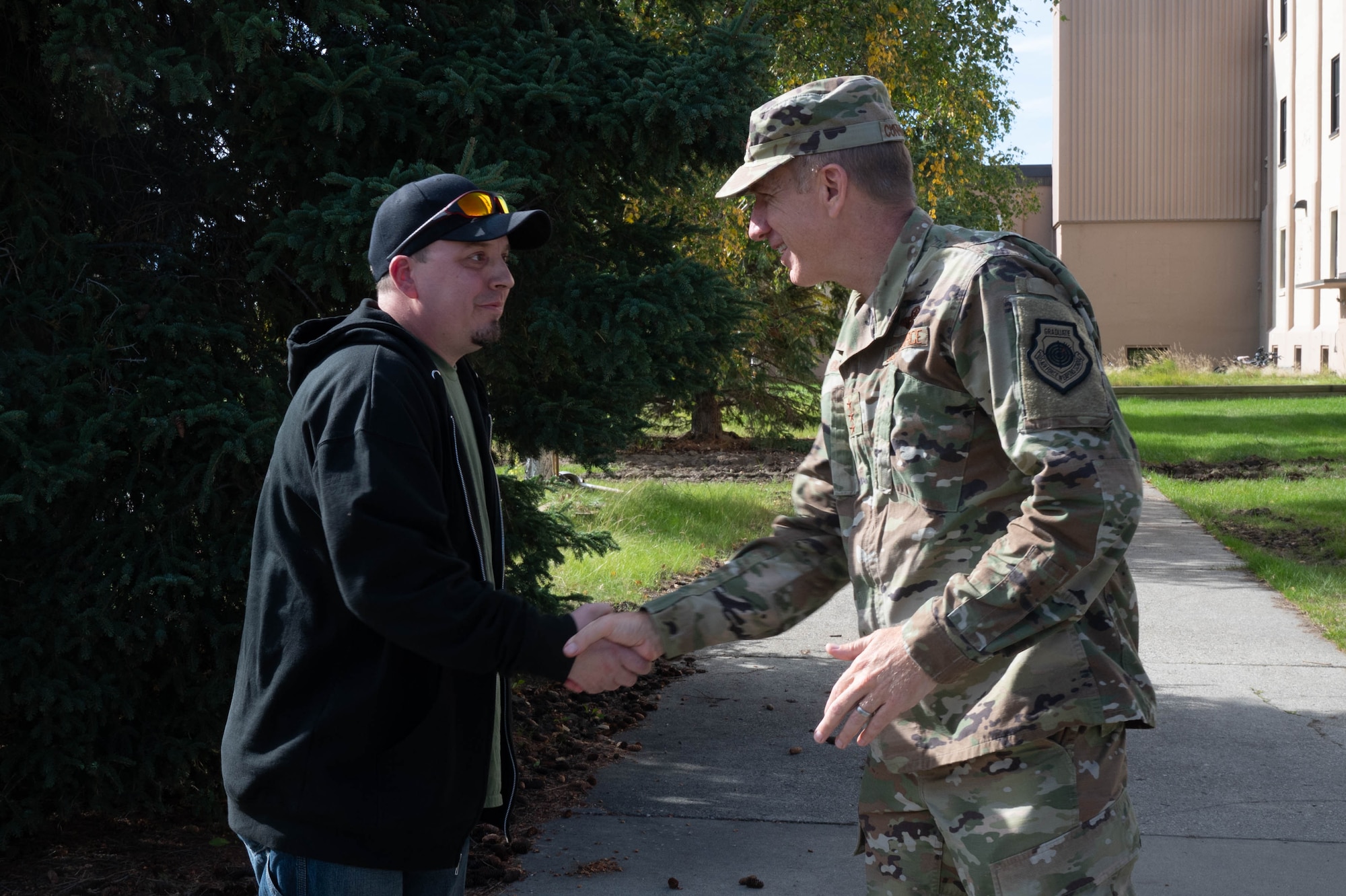 U.S. Air Force Lt. Gen. Case Cunningham, commander, Alaskan North American Aerospace Defense Region, Alaskan Command, and Eleventh Air Force, coins Mr. Daniel O’Connell 354th Communications Squadron cable specialist, during his immersion tour at Eielson Air Force Base, Alaska, Aug. 28, 2024.