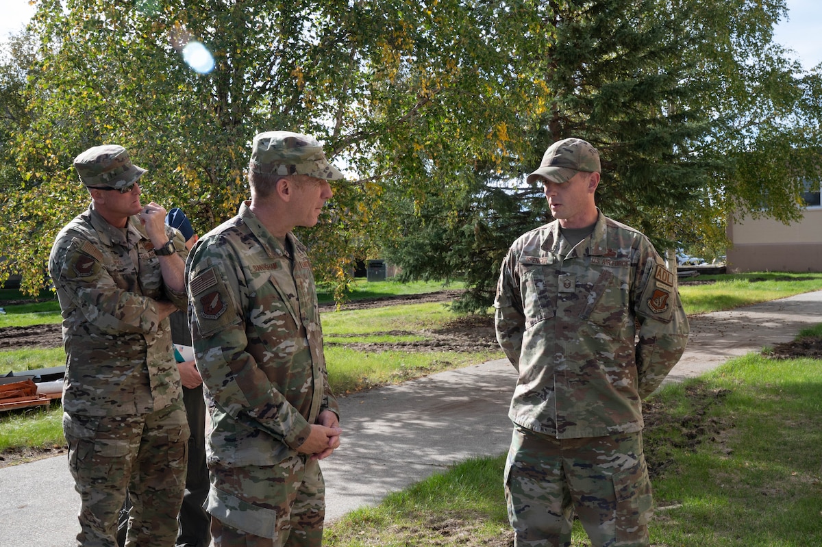 U.S. Air Force Lt. Gen. Case Cunningham, center, commander, Alaskan North American Aerospace Defense Region, Alaskan Command, and Eleventh Air Force; and Chief Master Sgt. Heath Tempel, left, command chief, Alaska NORAD Region, Alaskan Command, and Eleventh Air Force listen to Master Sgt. Adam Spencer, 354th Civil Engineer Squadron unaccompanied housing superintendent during an immersion tour at Eielson Air Force Base, Alaska, Aug. 28, 2024.