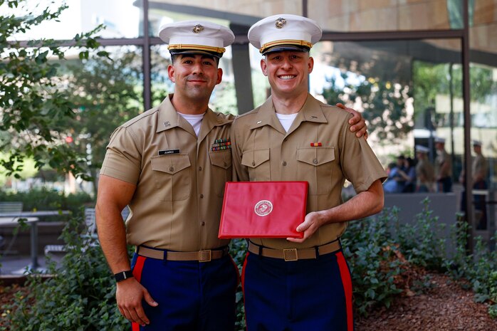 U.S. Marine Corps 1st Lt. Donald Griffith, a soon to be judge advocate, takes a photo with Capt. Daniel Juarez, the officer selection officer for Recruiting Station Phoenix, after being promoted in front of Sandra Day O'Connor School of Law, Phoenix, Arizona, Aug. 27, 2024. Griffith is a 2024 Arizona State University Law School alumni. Upon passing his bar exam, he will move on to be a judge advocate. (U.S. Marine Corps photo by Sergeant Symira Bostic)