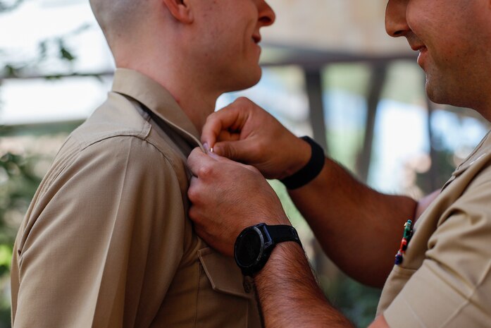 U.S. Marine Corps 1st Lt. Donald Griffith, a soon to be judge advocate, is promoted by Capt. Daniel Juarez in front of Sandra Day O'Connor School of Law, Phoenix, Arizona, Aug. 27, 2024. Griffith is a 2024 Arizona State University Law School alumni. Upon passing his bar exam, he will move on to be a judge advocate. (U.S. Marine Corps photo by Sergeant Symira Bostic)