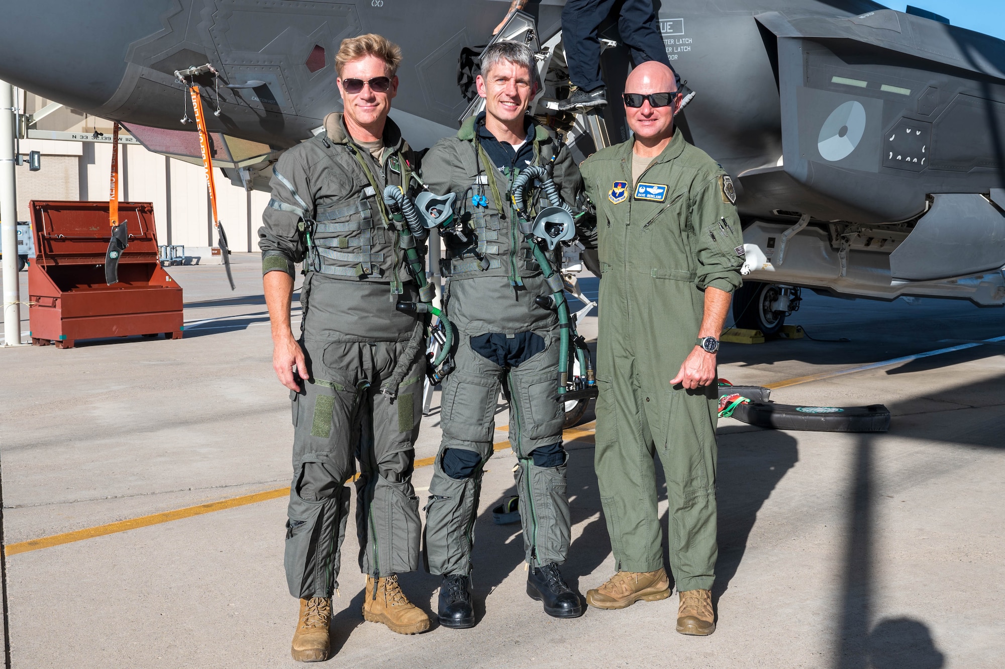 U.S. Air Force Col. David Berkland (right), 56th Fighter Wing commander, poses with Ryan Blake (middle), Lockheed Martin pilot, and Royal Danish Air Force Maj. Peter Borre (left), 308th Fighter Squadron student pilot, in front of an U.S. Air Force F-35A Lighting II after a training sortie, Aug. 29, 2024, at Luke Air Force Base, Arizona.