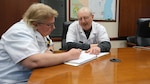 Medical Technicians Linda Jacobson and Don Roth review documentation together. The pair has been working together as a brother-sister duo for more than 30 years at the Milwaukee MEPS.