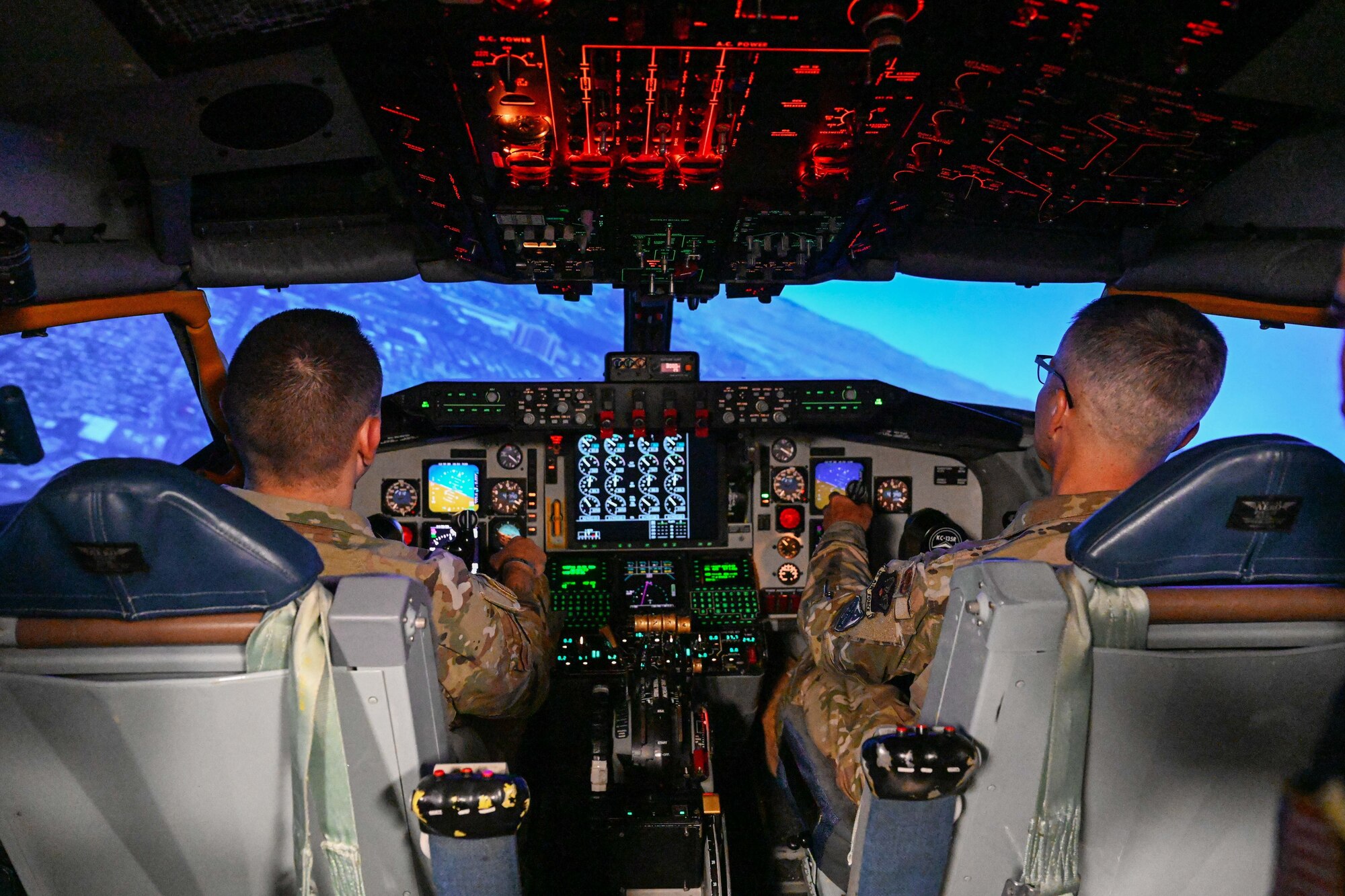 U.S. Air Force Chief Master Sgt. James Woods, Chief, Medical Enlisted Force, left, and Lt. Gen. John J. DeGoes, U.S. Air Force Surgeon General, fly a KC-135 Stratotanker aircraft simulator at Altus Air Force Base, Oklahoma, Aug. 26, 2024. DeGoes and Woods also operated a KC-135 boom operator simulator, where they refueled multiple fighter jets. (U.S. Air Force photo by Airman 1st Class Jonah Bliss)