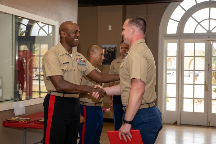 U.S. Marine Corps Brig. Gen. James A Ryan II, the commanding general of Marine Corps Recruit Depot San Diego, left, congratulates an officer with the Marine Corps Recruiting Command who is being recognized for his outstanding performance and diligent efforts of the Western Recruiting Region Recruiting Offensive “Operation Overlord” at MCRD San Diego, California, Aug. 1, 2024. Operation Overlord was a summer recruiting offensive held to foster competition amongst the recruiting force and increase productivity, while creating a contracting momentum for fiscal year 2025.  (U.S. Marine Corps photo by Cpl. Sarah M. Grawcock)