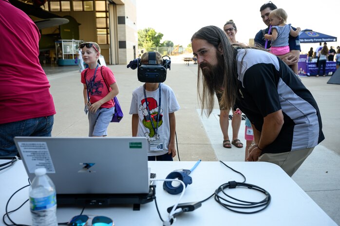 Austin Herrera, Ogden Air Logistics Complex, guides a student through a virtual reality experience at Hill Air Force Base, Utah, Sept. 5, 2024. Purple Star is a state program that supports military-connected children to provide smooth transitions for military families. The museum teamed up with the Davis County School District for the event. (U.S. Air Force photo by R. Nial Bradshaw)