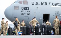 Airmen load up on a airplane.