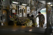 Airmen load cargo.