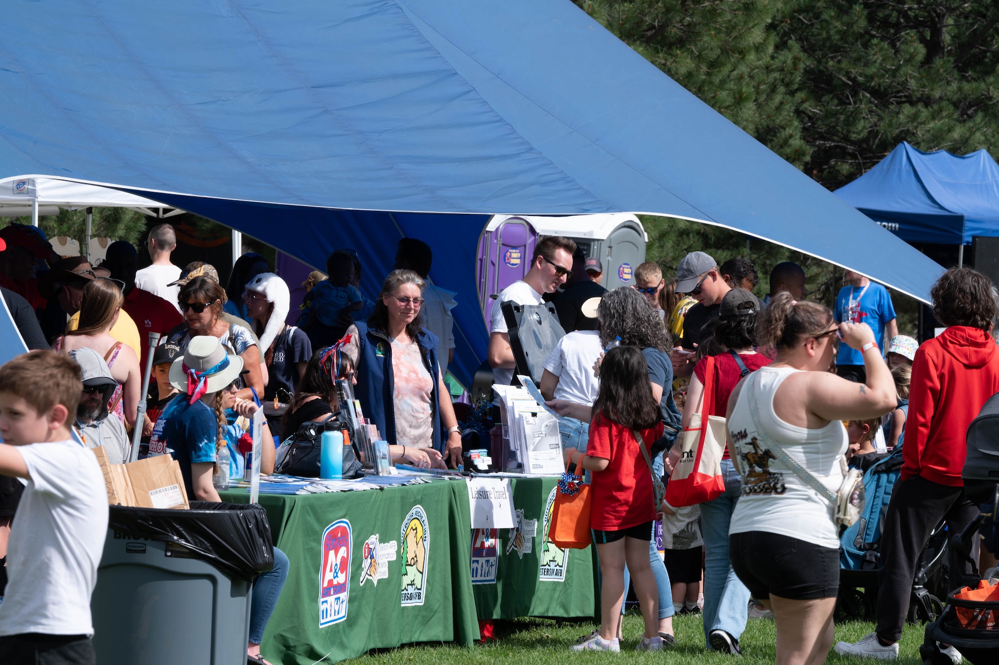 Local organizations have set up tents and are interacting with the crowds.
