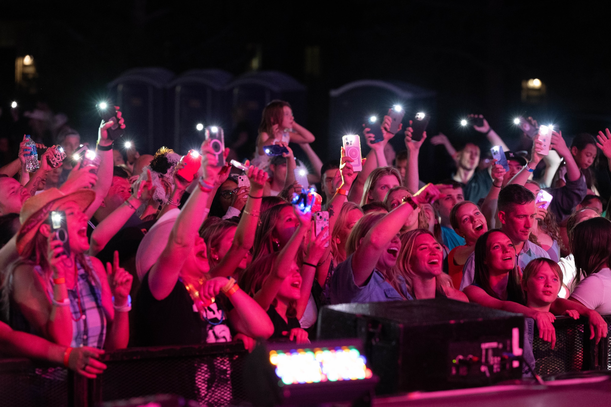 Fans by the stage hold out their phones' flashlight to the Lauren Alaina perfomance