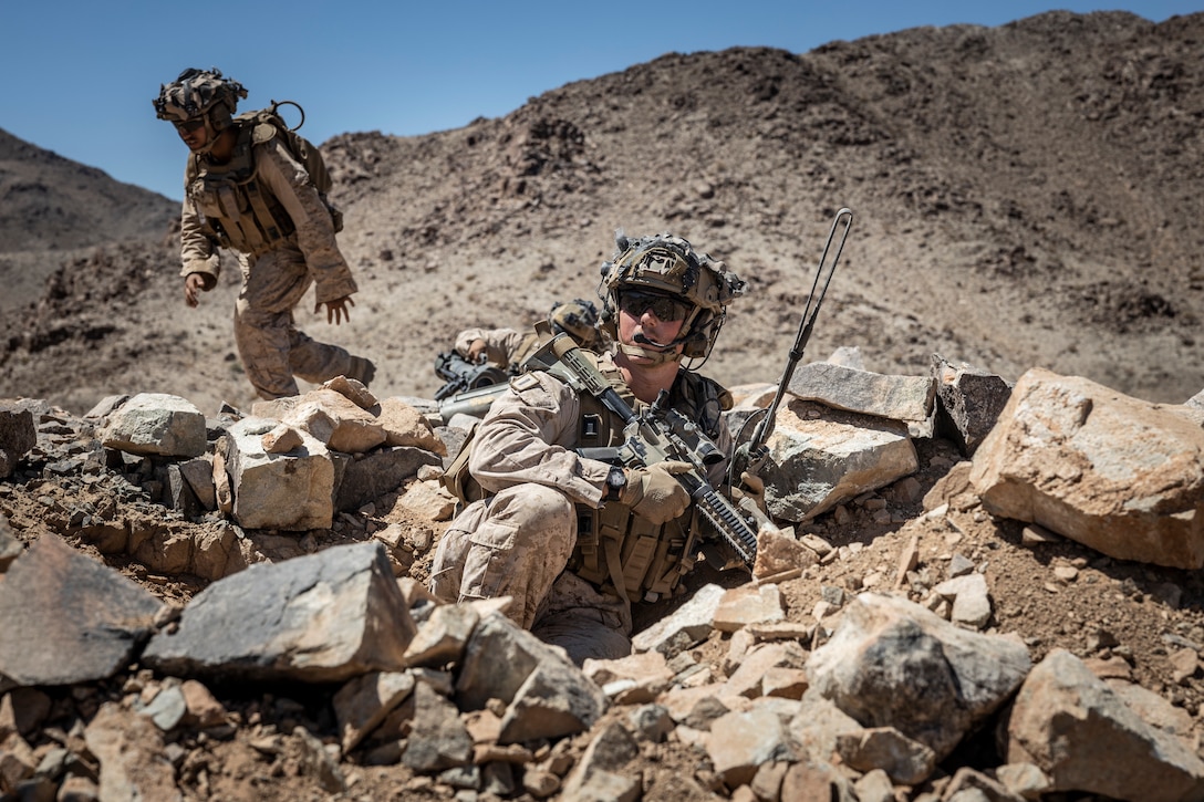 U.S. Marine Corps 1st Lt. Nicholas Wimer, a Fremont, Nebraska native, infantry officer with 3rd Battalion, 4th Marine Regiment (REIN), 7th Marine Regiment, gives his Marines an order during a Marine Air-Ground Task Force Distributed Maneuver Exercise as part of Service Level Training Exercise 5-24 at Training Area West, MCAGCC, Twentynine Palms, California, Aug. 15, 2024. MDMX is a combined arms training event that combines live-fire and maneuver with virtual environments, expanding participating units' knowledge of the battlefield. SLTE 5-24 is purpose built to train, develop, and validate the Infantry Battalion Experiment as part of a larger MAGTF operation as a Stand-in Force across a contested multi-domain distributed environment. (U.S. Marine Corps photo by Lance Cpl. Enge You)