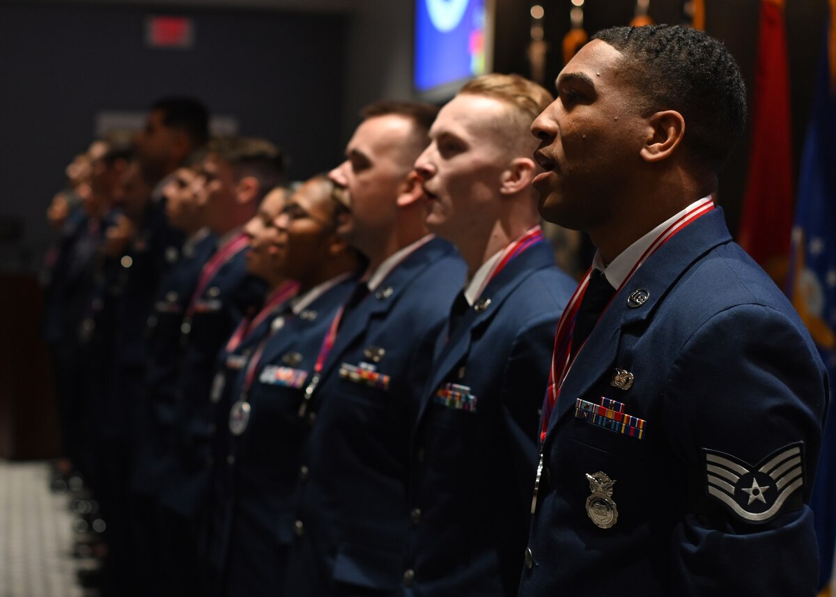 Airman Leadership School Class 24-F sing The Air Force Song at the end of their graduation at the Powell Event Center, Goodfellow Air Force Base, Texas, Sept. 5, 2024. The Air Force Song is sung at every ALS class graduation. (U.S. Air Force photo by Senior Airman Ethan Sherwood)