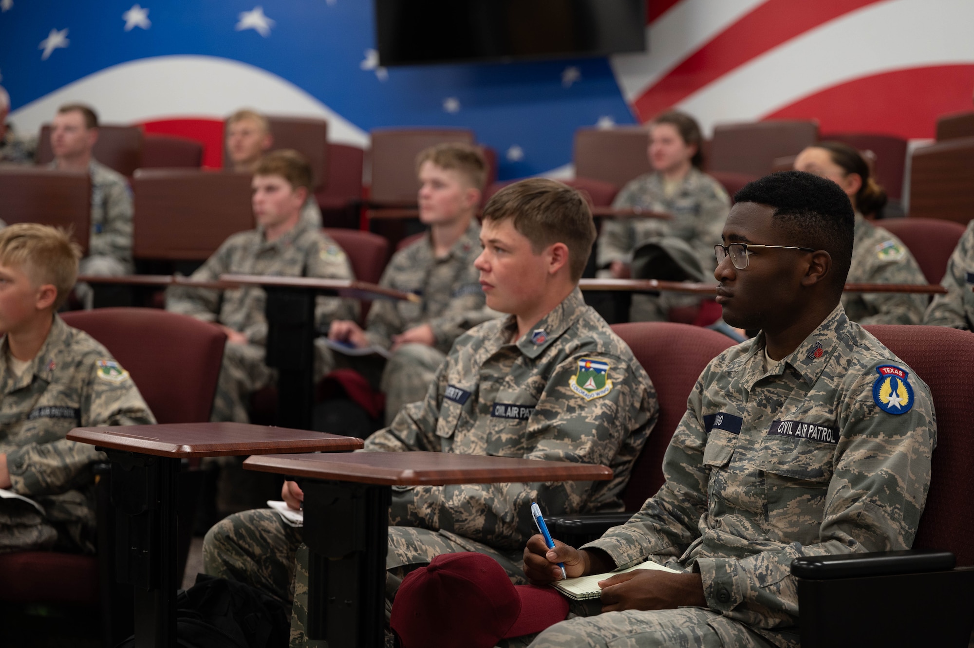 Cadets sit and listen to a lecture on aviation and its effects on human physiology