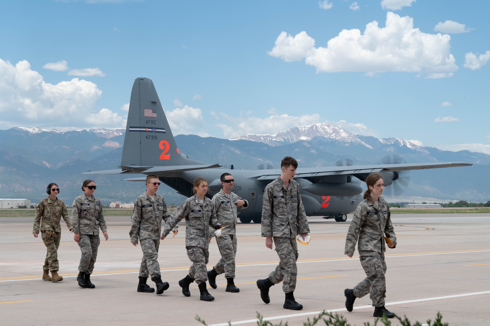 Cadets walk depart the flight line as they just finished their incentive flight on a C-130 Hercules.