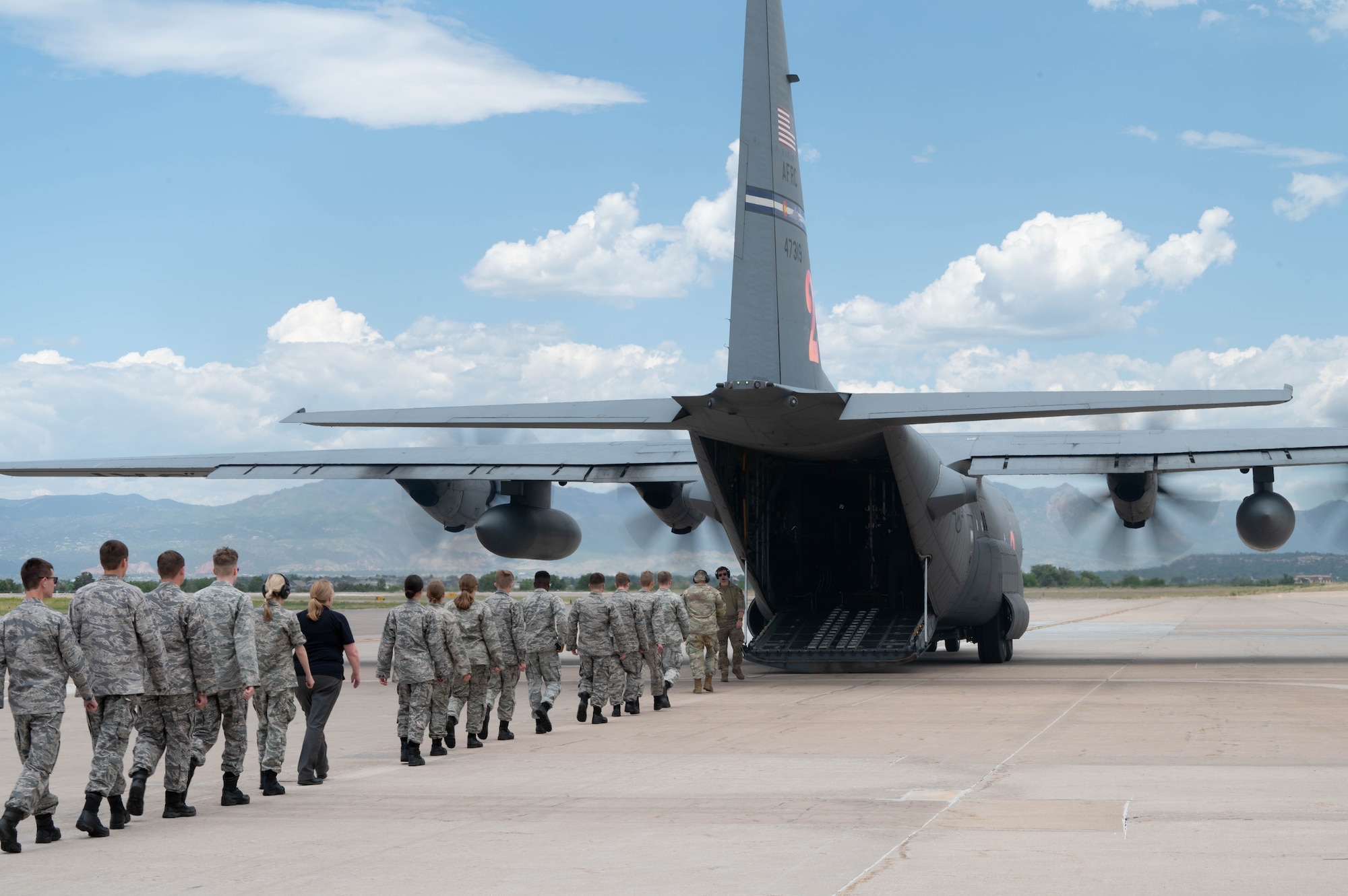 Cadets board a C-130 Hercules on the flight line on Peterson Space Force Base.