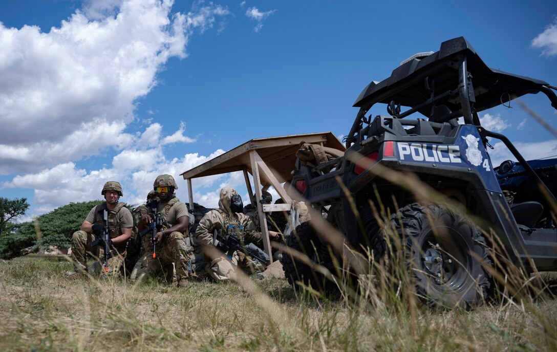 U.S. Air Force Tech. Sgt. Victor Hallett, 28th Civil Engineer Squadron lead firefighter (left), Senior Airman Deante Lewis, 28th CE driver operator (center) and Staff Sgt. Brock Pustejovsky, 28th Security Forces Squadron base defense operations center controller (right), guard a Defensive Fighting Position (DFP) after a simulated attack by enemy forces during a Cerberus Defender exercise at Ellsworth Air Force Base, S.D., 18 July, 2024. Cerberus Defender trained Airmen on the Military Decision-Making Process (MDMP), Decentralized Execution, Small Unit Tactics, Tactical Casualty Combat Care (TCCC), Chemical, Biological, Radiological, Nuclear and Explosives (CBRNE) defense scenarios as well as modernized defensive techniques against drone warfare to prepare for real-world combat operations. (U.S. Air Force photo by Senior Airman Josephine Pepin)