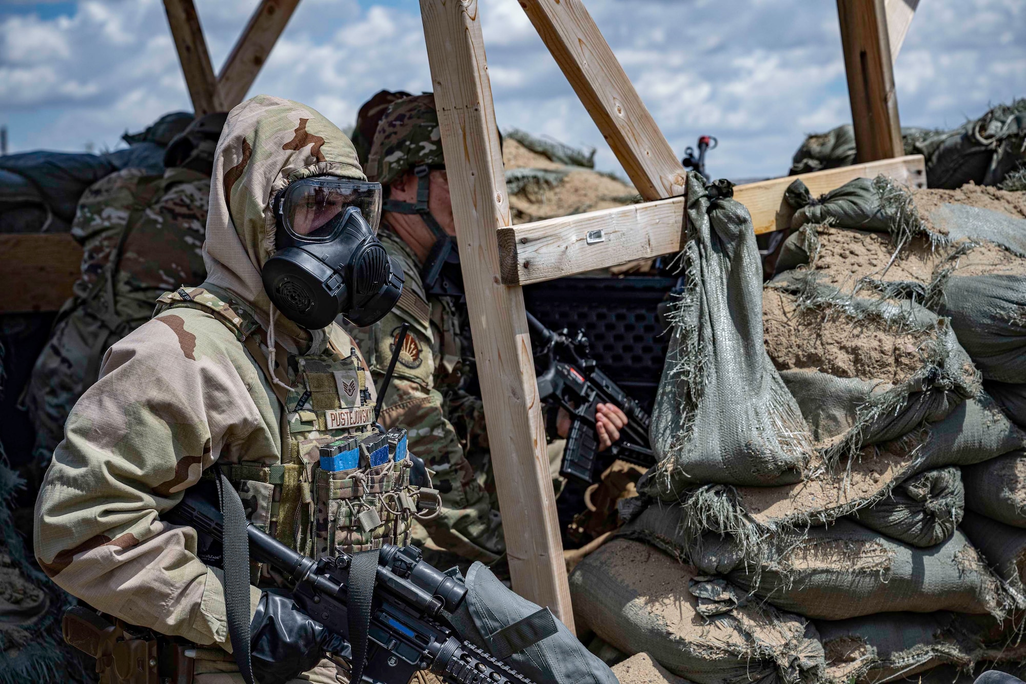 U.S. Air Force Staff Sgt. Brock Pustejovsky, a 28th Security Forces Squadron base defense operations center controller, dons Mission-Oriented Protective Posture 4 (MOPP 4) gear after a simulated Chemical, Biological, Radiological, Nuclear and Explosive (CBRNE) attack by enemy forces during a Cerberus Defender exercise at Ellsworth Air Force Base, S.D., 18 July, 2024. CBRNE techniques was incorporated into the exercise as part of routine training Airmen undergo to remain deployment-ready. (U.S. Air Force photo by Senior Airman Josephine Pepin)