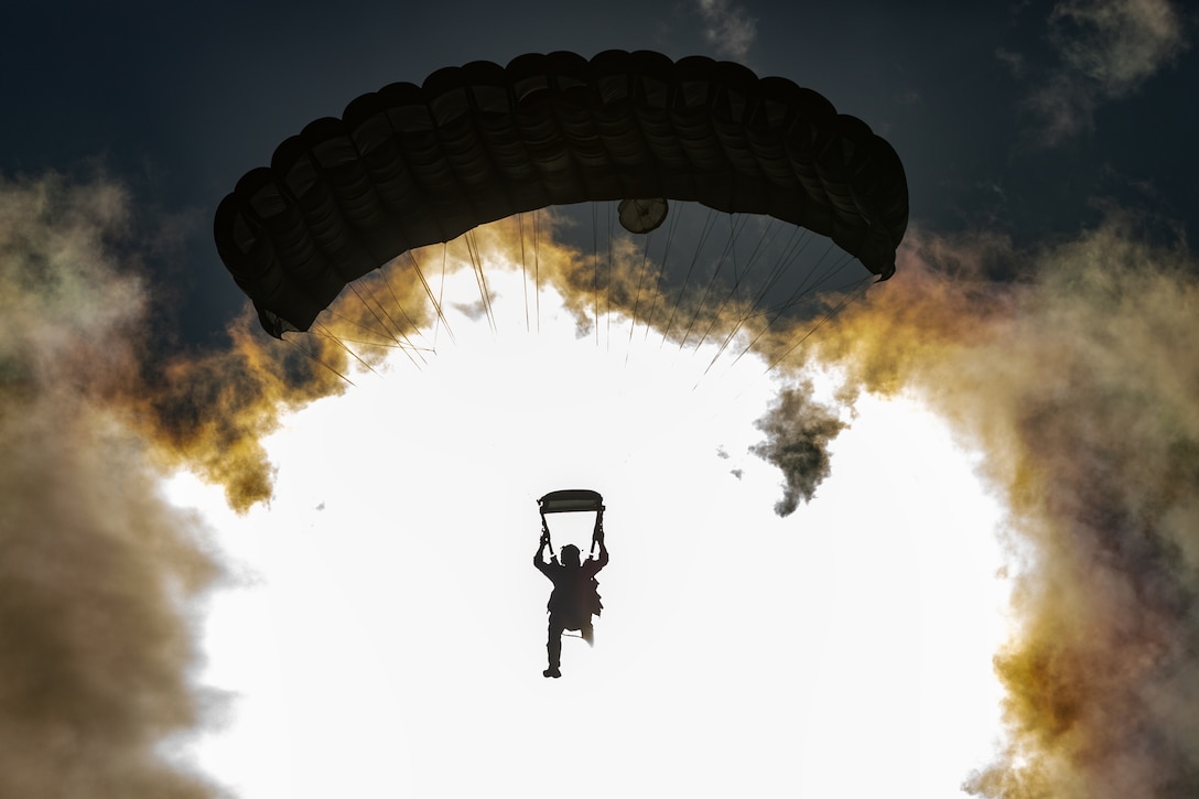 An Alaska Air National Guard Guardian Angel assigned to the 212th Rescue Squadron descends over Malemute Drop Zone during a capabilities exercise at Joint Base Elmendorf-Richardson, Alaska, June 25, 2024. Guardian Angels, highly trained personnel recovery specialists, jumped to two plane crash sites during several Labor Day Weekend rescues across the state.