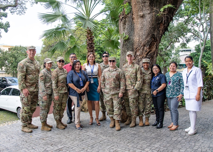 A group photo of people in U.S. military uniform and civilian clothes.