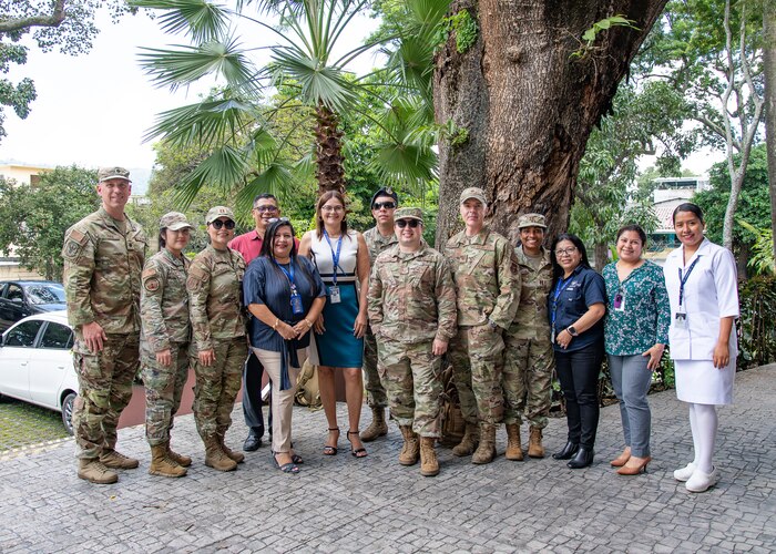 A group photo of people in U.S. military uniform and civilian clothes.