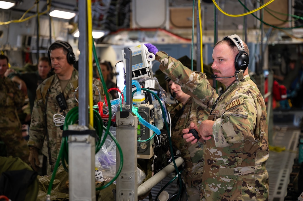 U.S. Air Force Tech. Sgt. Joshua Alley, right, respiratory care practitioner, 134th Air Refueling Wing, Tennessee National Guard, trains alongside other critical care air transport team members in properly allocating resources in the event of an inflight patient emergency during a Medical Readiness University capstone exercise at Alpena Combat Readiness Training Center, Alpena, Michigan, June 13, 2024. This large-scale training event provided Total Force Airmen with hands-on and real-world operational training at a reduced cost for more than 21 medical career specialties. (U.S. Air National Guard photo by Tech. Sgt. Sarah M. McClanahan)