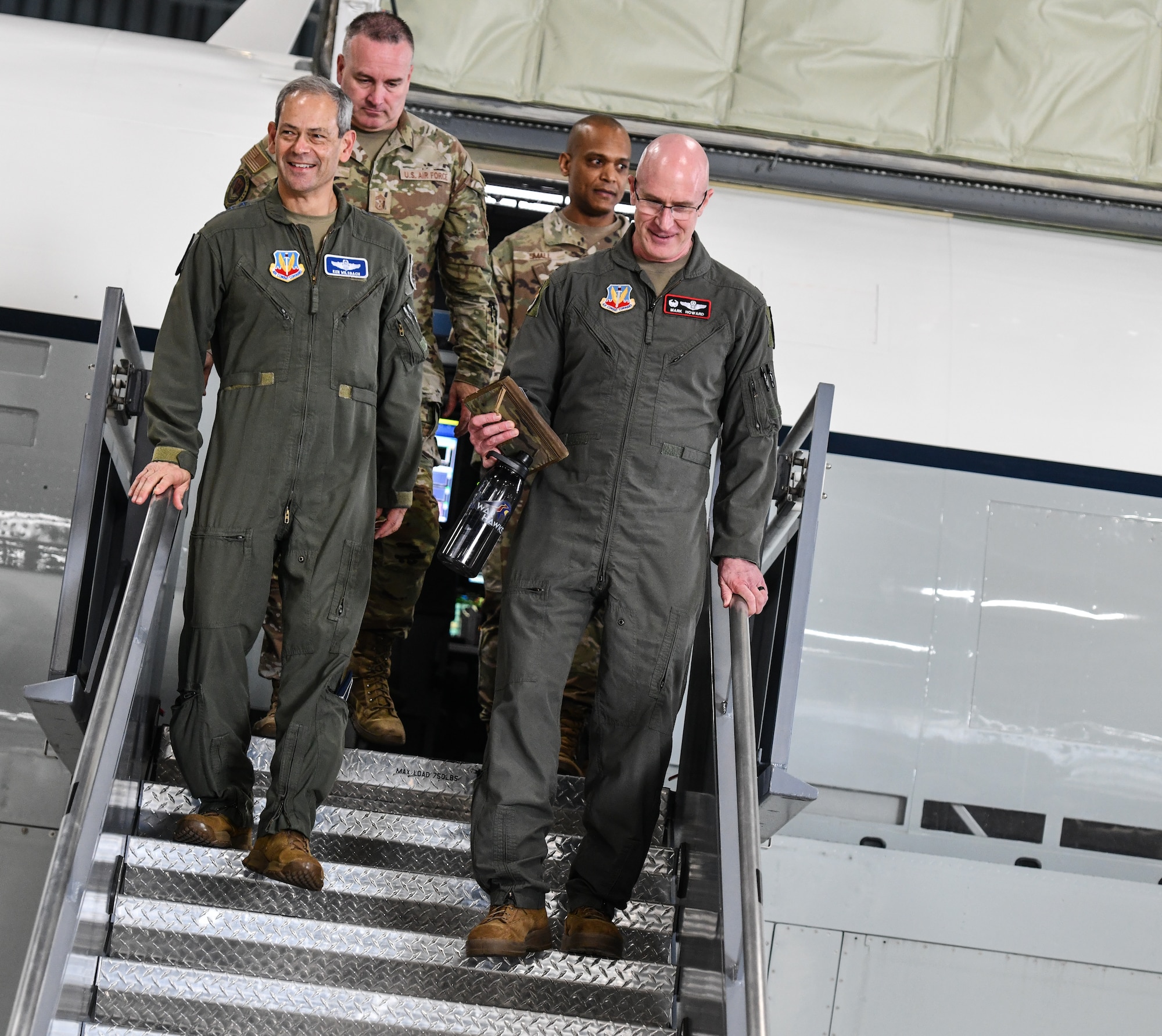 U.S. Air Force Gen. Ken Wilsbach, commander of Air Combat Command, exits an RC-135 RIVET JOINT with Col. Mark Howard, 55th Wing commander, Chief Master Sgt. David Wolfe, ACC command chief, and Chief Master Sgt. Andrew Small, 55th Wing command chief on Aug. 19, 2024, at Offutt Air Force Base.