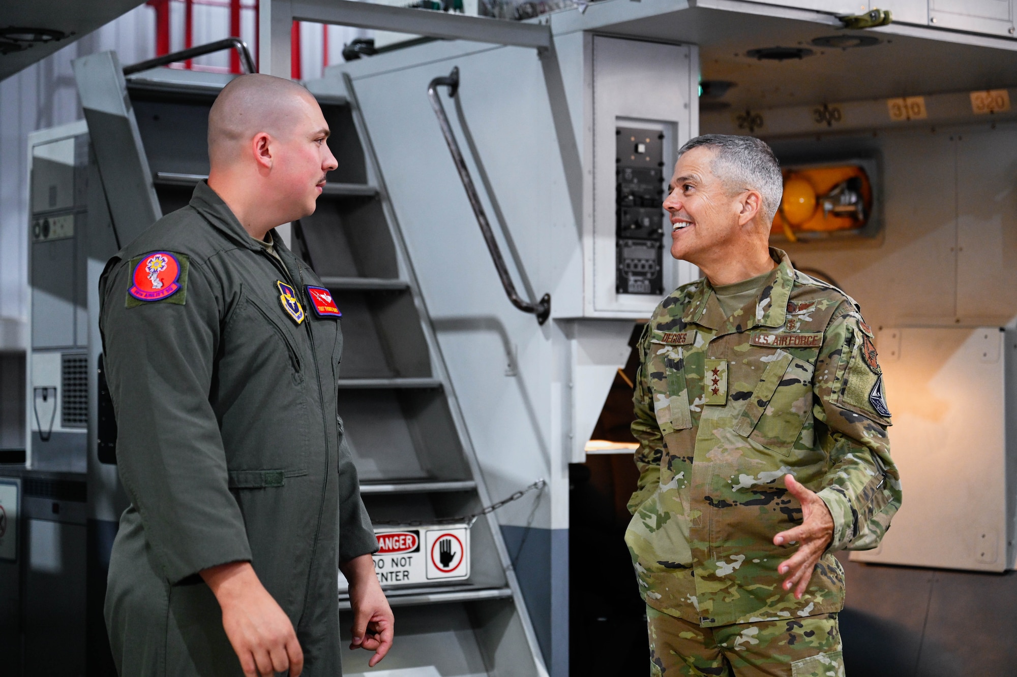 U.S. Air Force Lt. Gen. John J. DeGoes, U.S. Air Force Surgeon General, talks to Tech. Sgt. Thomas Olney, 58th Airlift Squadron (AS) instructor loadmaster, at Altus Air Force Base, Oklahoma, Aug. 26, 2024. Olney and other members of the 58th AS showcased their abilities to load cargo onto a C-17 Globemaster III aircraft. (U.S. Air Force photo by Airman 1st Class Jonah Bliss)